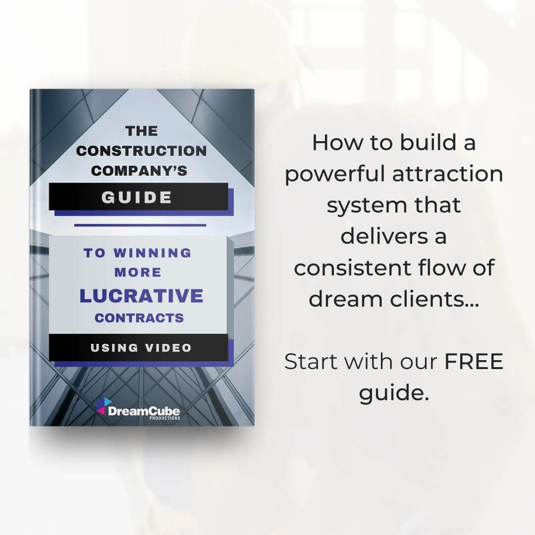 This image shows a promotional graphic for DreamCube Productions' guidebook titled "The Construction Company’s Guide to Winning More Lucrative Contracts Using Video". The cover of the guide is displayed in the center against a blurred background, with text on the right side stating "How to build a powerful attraction system that delivers a consistent flow of dream clients... Start with our FREE guide." The cover features geometric designs and the DreamCube Productions logo, suggesting a focus on helping construction businesses secure profitable contracts through video marketing strategies.